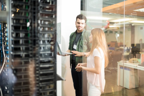Two employees checking the servers