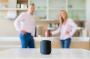 A couple stands near voice assistants that may have been accidentally triggered. 