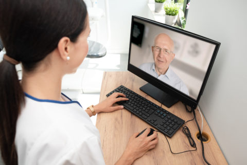 A doctor uses telehealth to communicate with a patient.