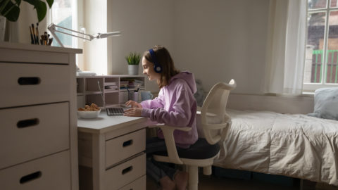 A student on the computer, possibly discussing mental health